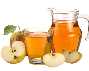 Apple Juice in a clear pitcher with sliced apples.