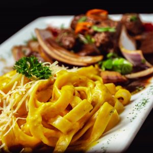 Pasta with Cheese Sauce and fried Meat.