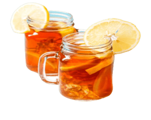 Iced tea in two clear glass with lemon on side of glass mug.